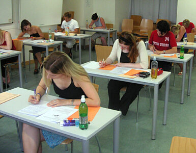 Students taking a standardized test in a classroom, representing the PSAT/NMSQT.