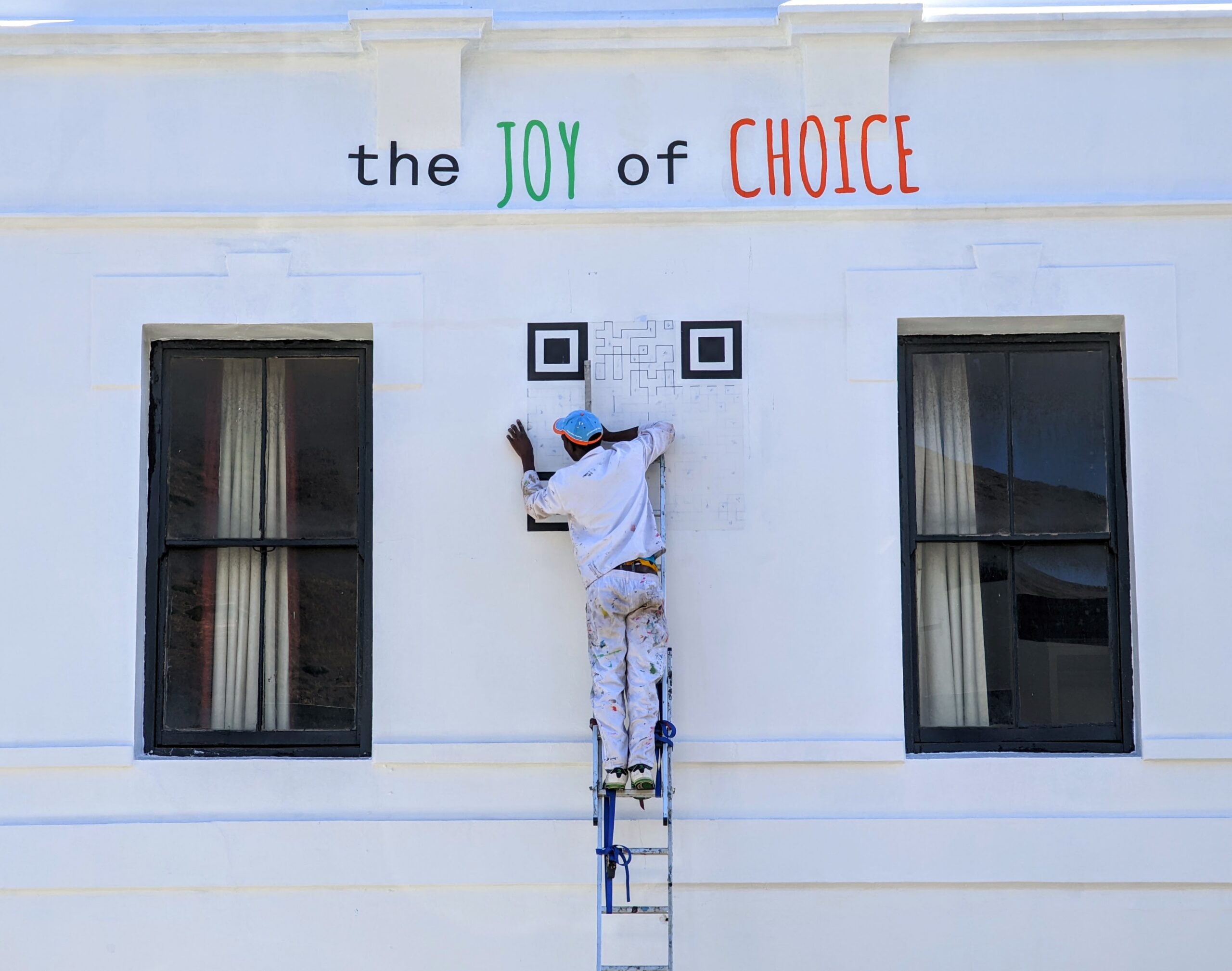 A large QR code painted on a wall, showing the square patterns that help scanners read encoded data.