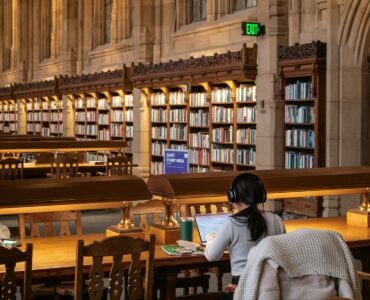 A student studies quietly in a library after using reading strategies to understand a text.