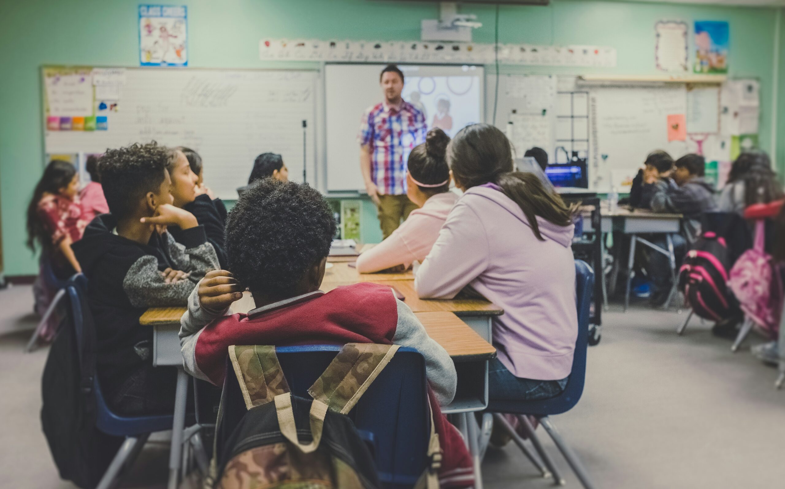 Students listening in a classroom where regular routines and support can make attendance easier