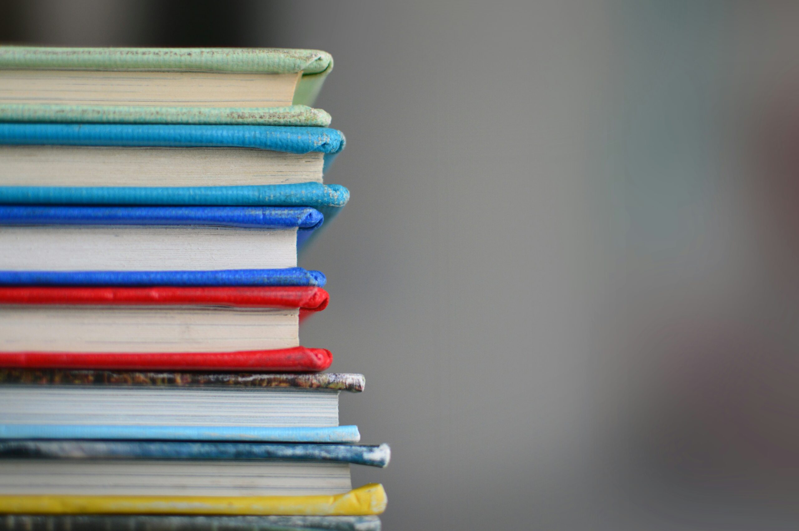 A stack of school books representing the weight students often add to a backpack