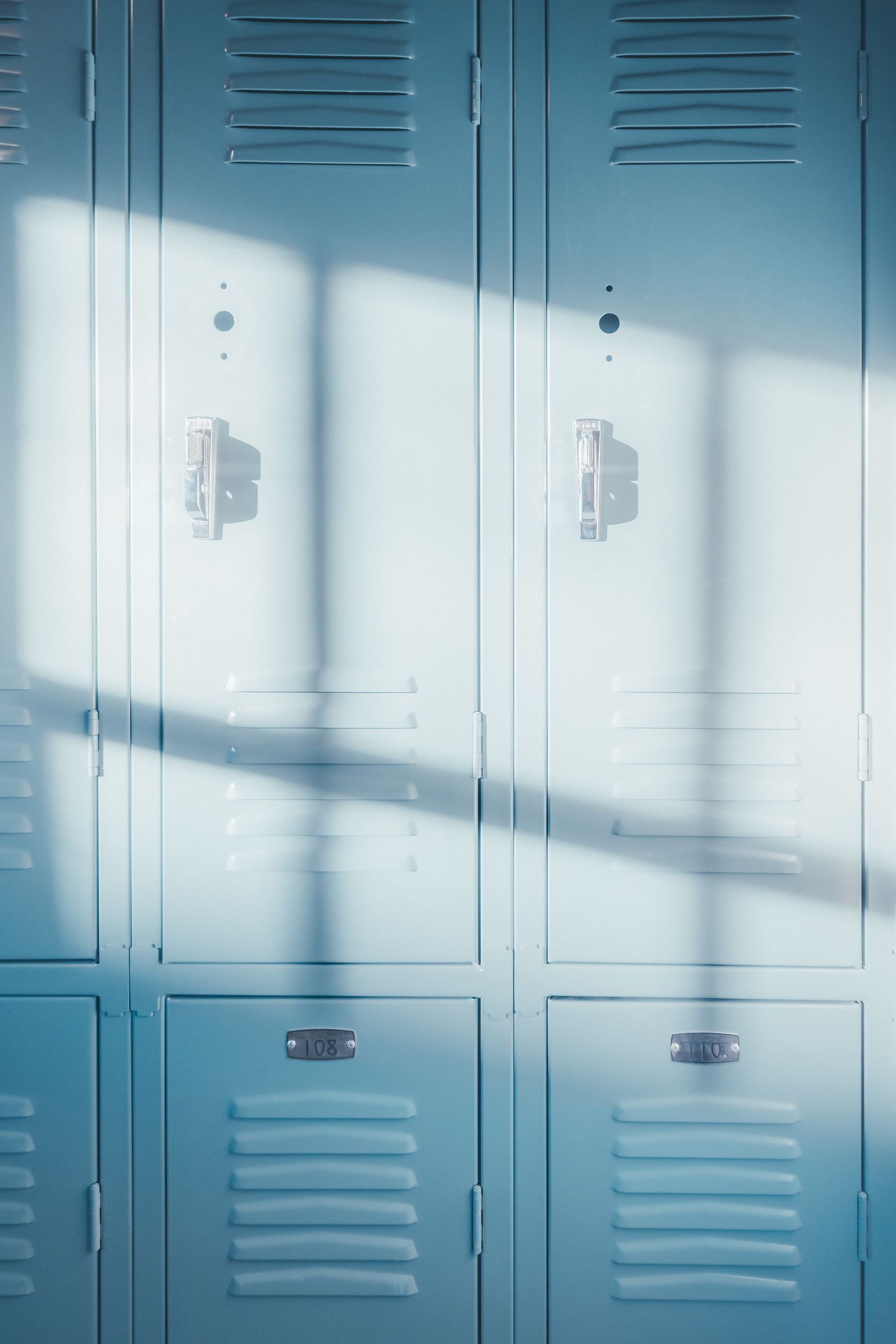 A quiet school hallway with lockers, representing the everyday setting where school dress code rules are applied.