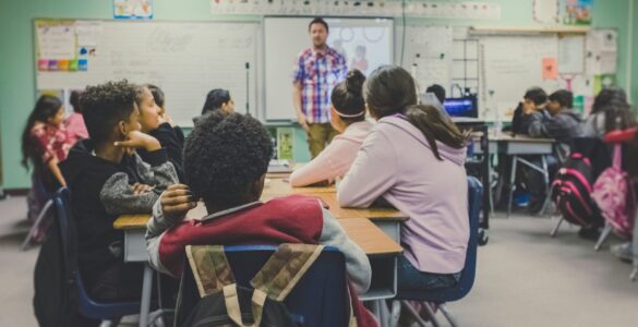 Students learning in a supportive classroom where clear school rules can shape belonging and focus.
