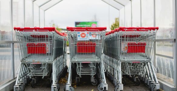 Rows of shopping carts at a store entrance, representing retail sales patterns that change with the season.