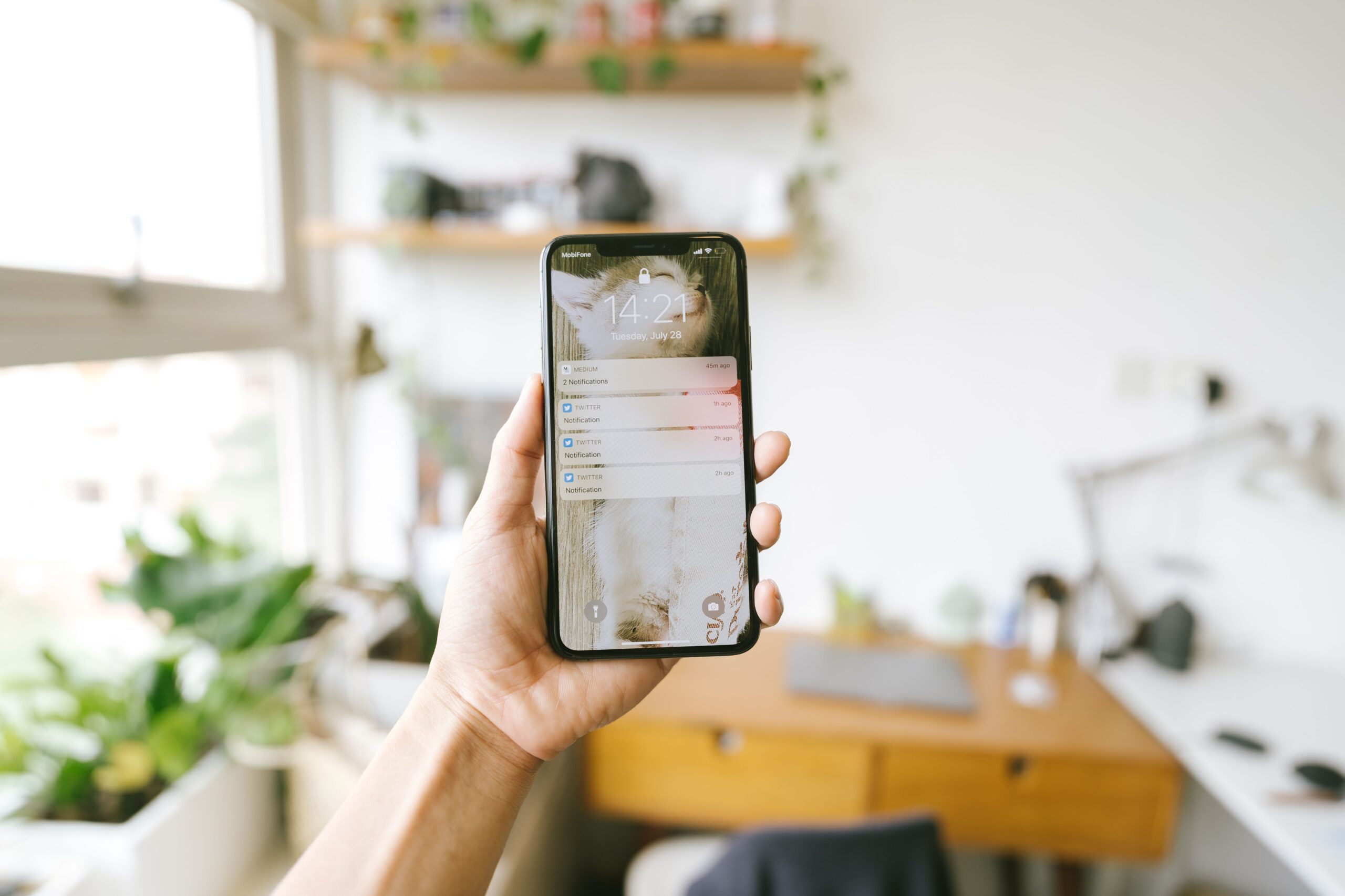 A student holding a smartphone, representing how social media videos can shape back-to-school shopping expectations.