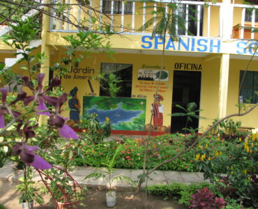 A Spanish language classroom with desks and learning materials.