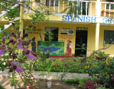 A Spanish language classroom with desks and learning materials.