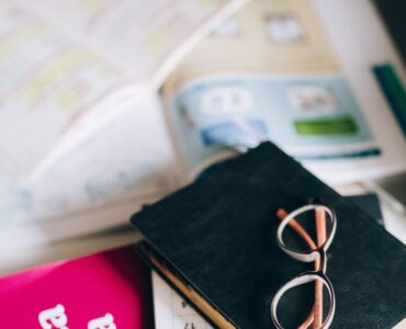 Spanish grammar book and study notes for practicing stem-changing verbs