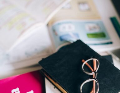 Spanish grammar book and study notes for practicing stem-changing verbs