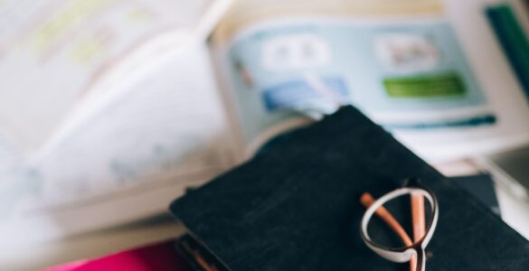 Spanish grammar book and study notes for practicing stem-changing verbs