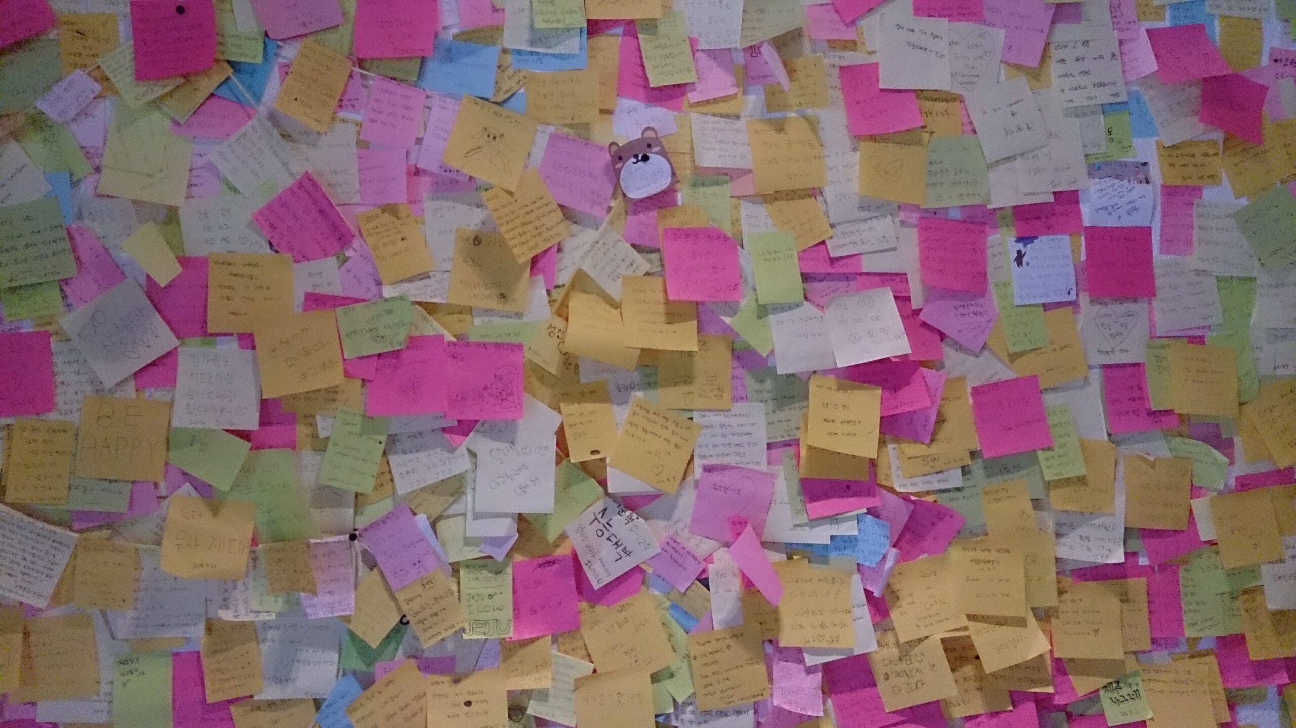 Several sticky notes on a study desk, illustrating how removable adhesive can hold paper temporarily.