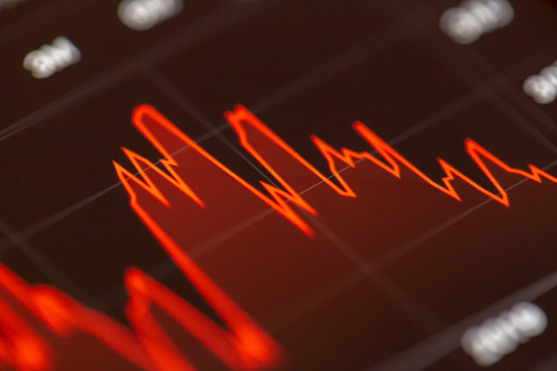A stock market ticker board with rows of changing numbers.
