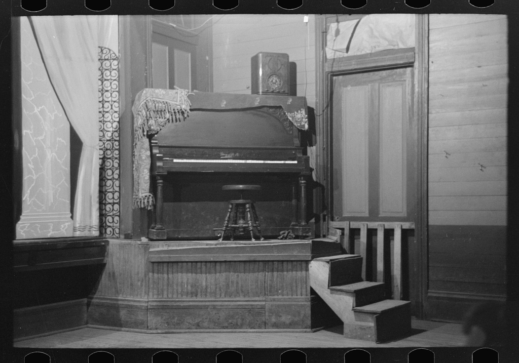 A piano on the stage of an auditorium in 1938