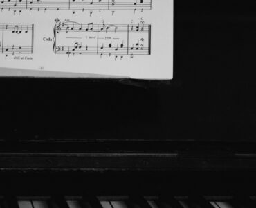 Sheet music and piano keys used to practice reading lower notes in bass clef.