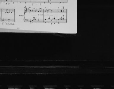 Sheet music and piano keys used to practice reading lower notes in bass clef.