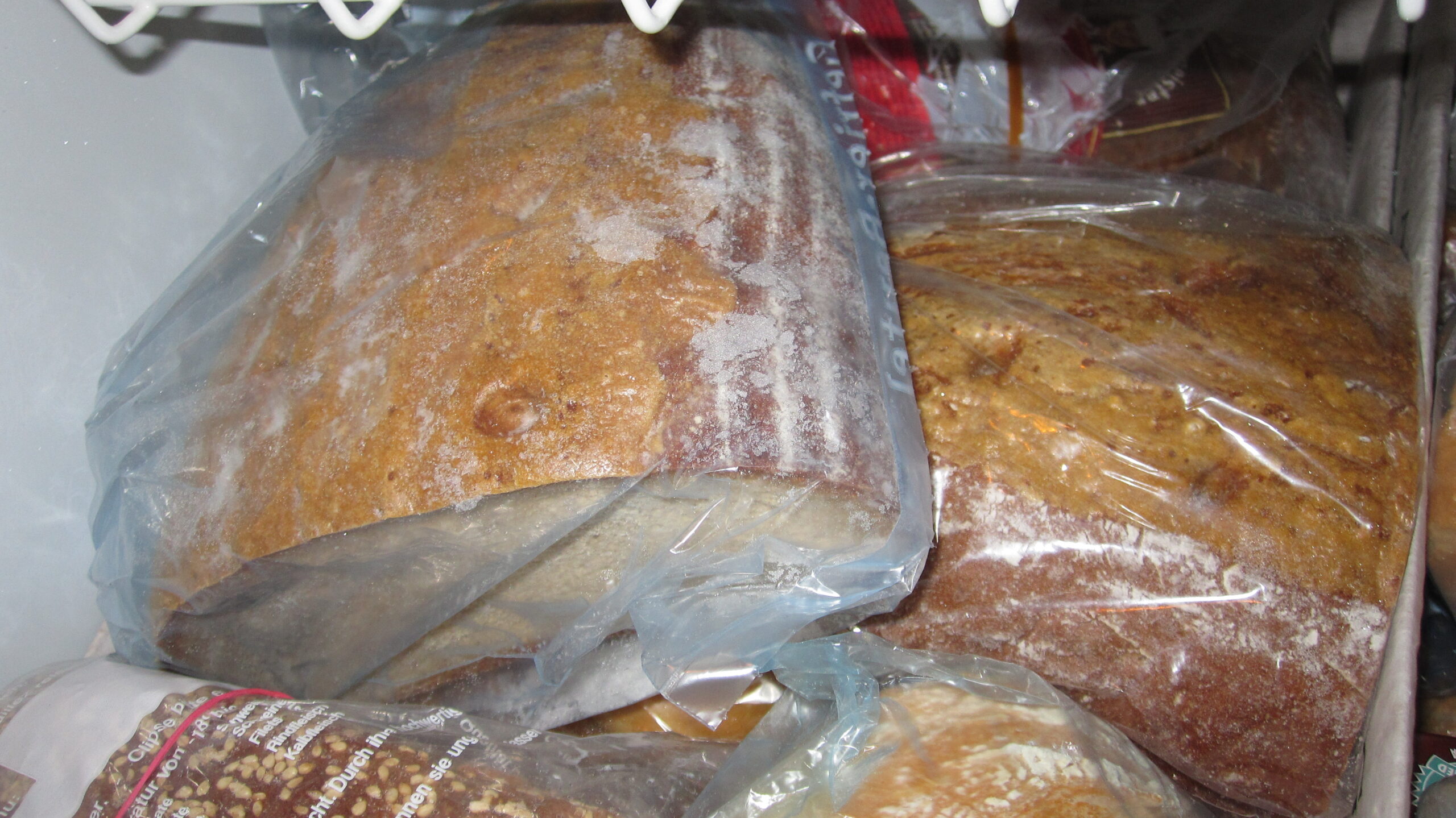 Loaf of bread sealed in a bag inside a freezer