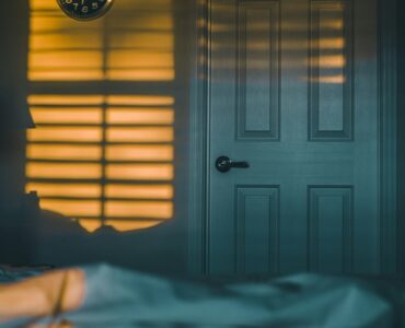 A quiet bedroom at night, where closing the door can slow the spread of smoke and heat during a house fire.