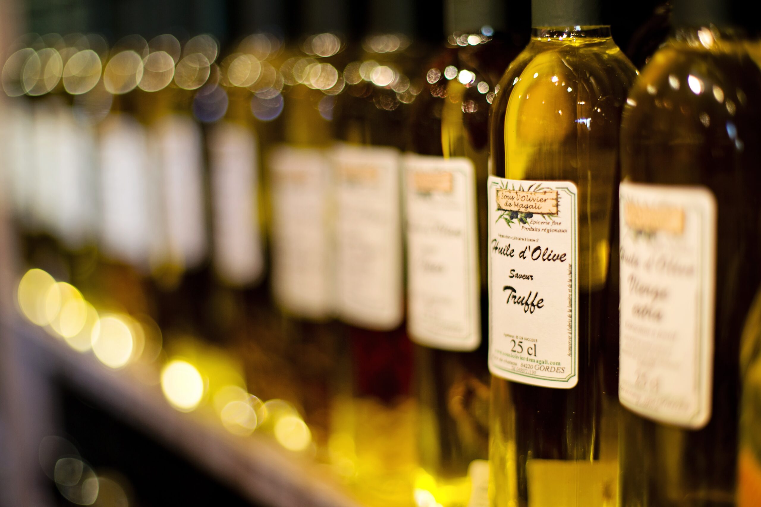 Bottles of cooking oil on a kitchen surface, representing the thin layer that helps manage heat and food release.