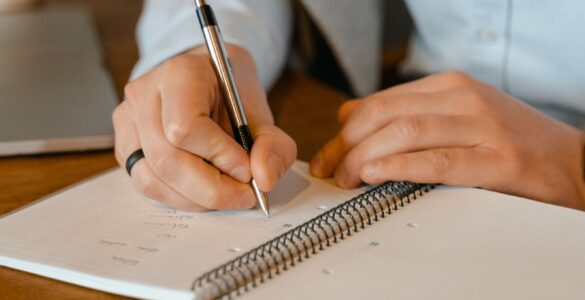 Writer revising dialogue by hand in an open notebook