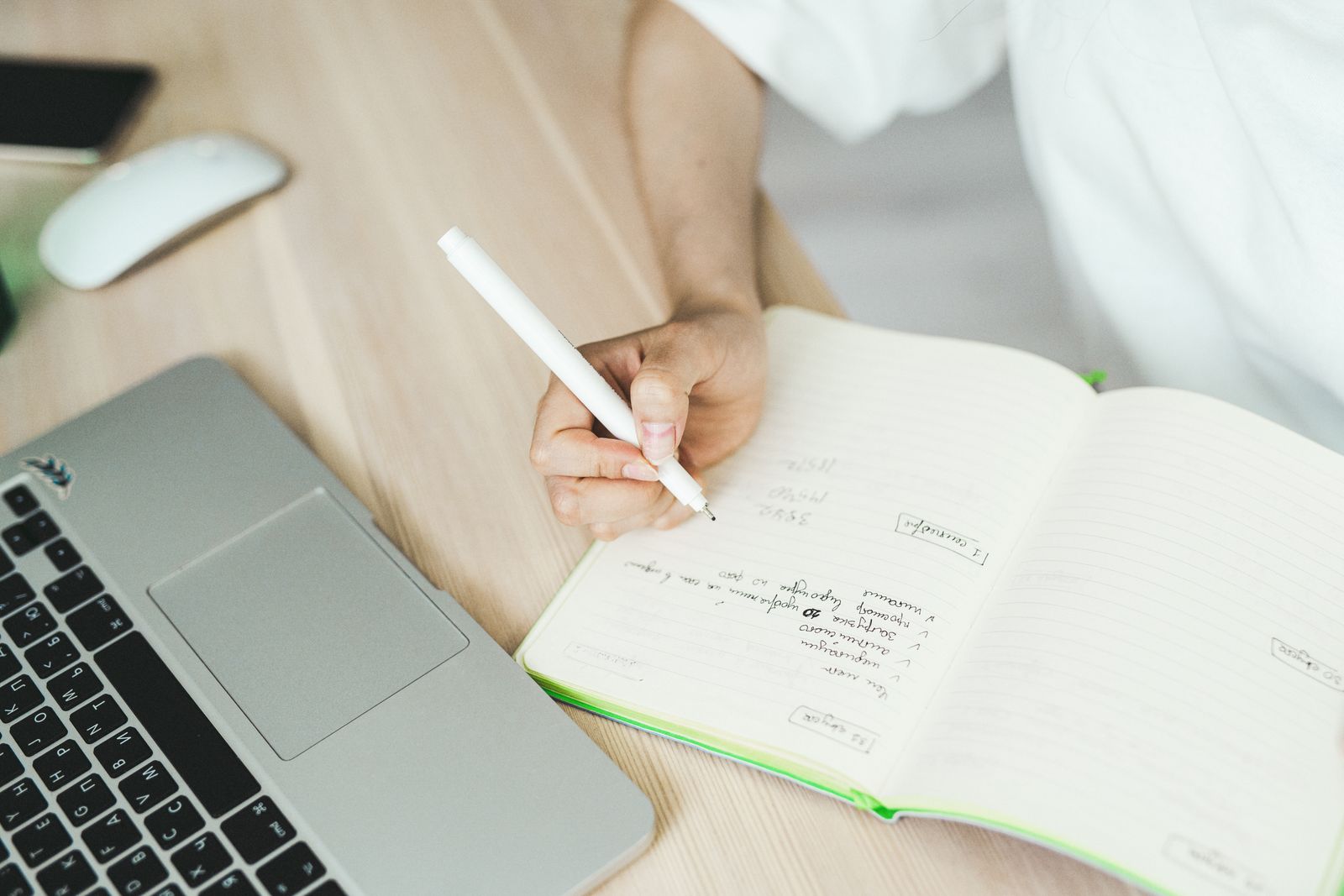 Student checking quotation marks and dialogue in a notebook