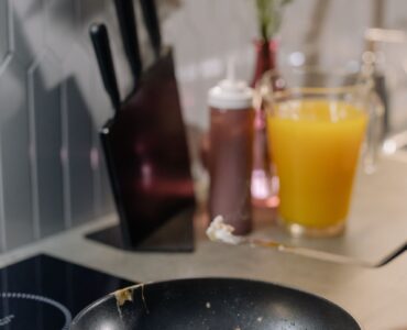 An egg cooks in a pan as heat turns liquid proteins into a firmer white and yolk.