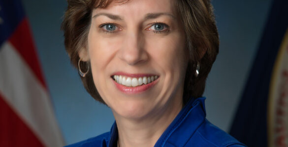 Ellen Ochoa in an official NASA portrait, wearing a blue jacket.