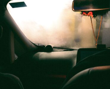 Fogged windshield obscuring the view from inside a parked car