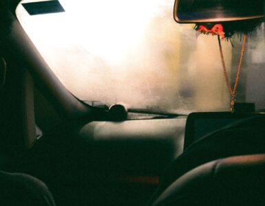 Fogged windshield obscuring the view from inside a parked car