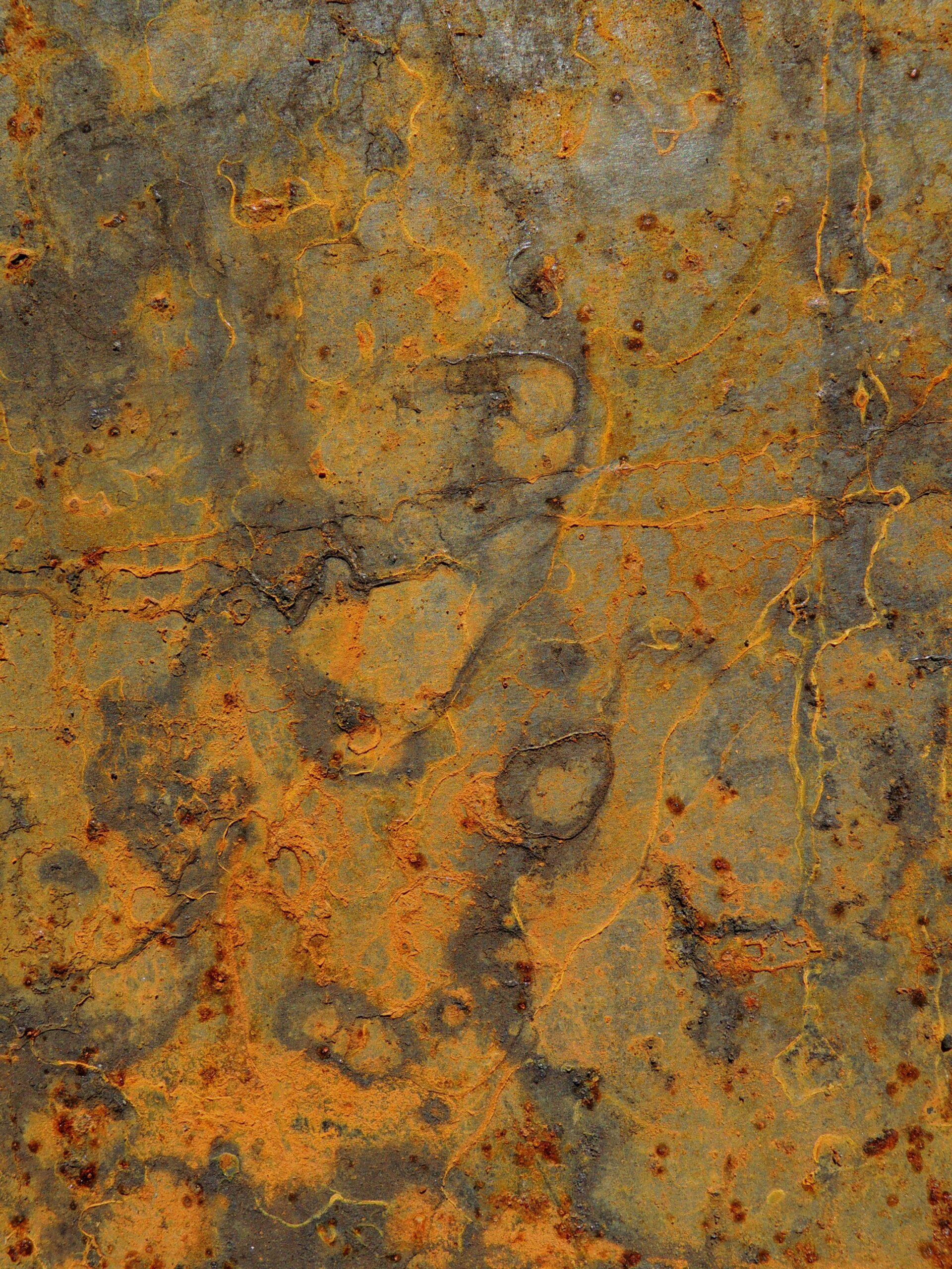 Orange and brown rust spreading across iron, showing the oxidation chemistry used inside disposable hand warmers.