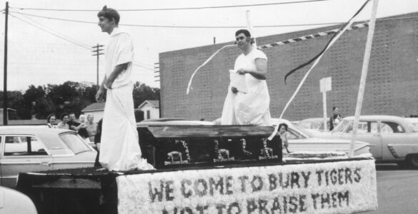Two students in costume ride on an Arlington State College homecoming float, showing how pageantry became part of school tradition.