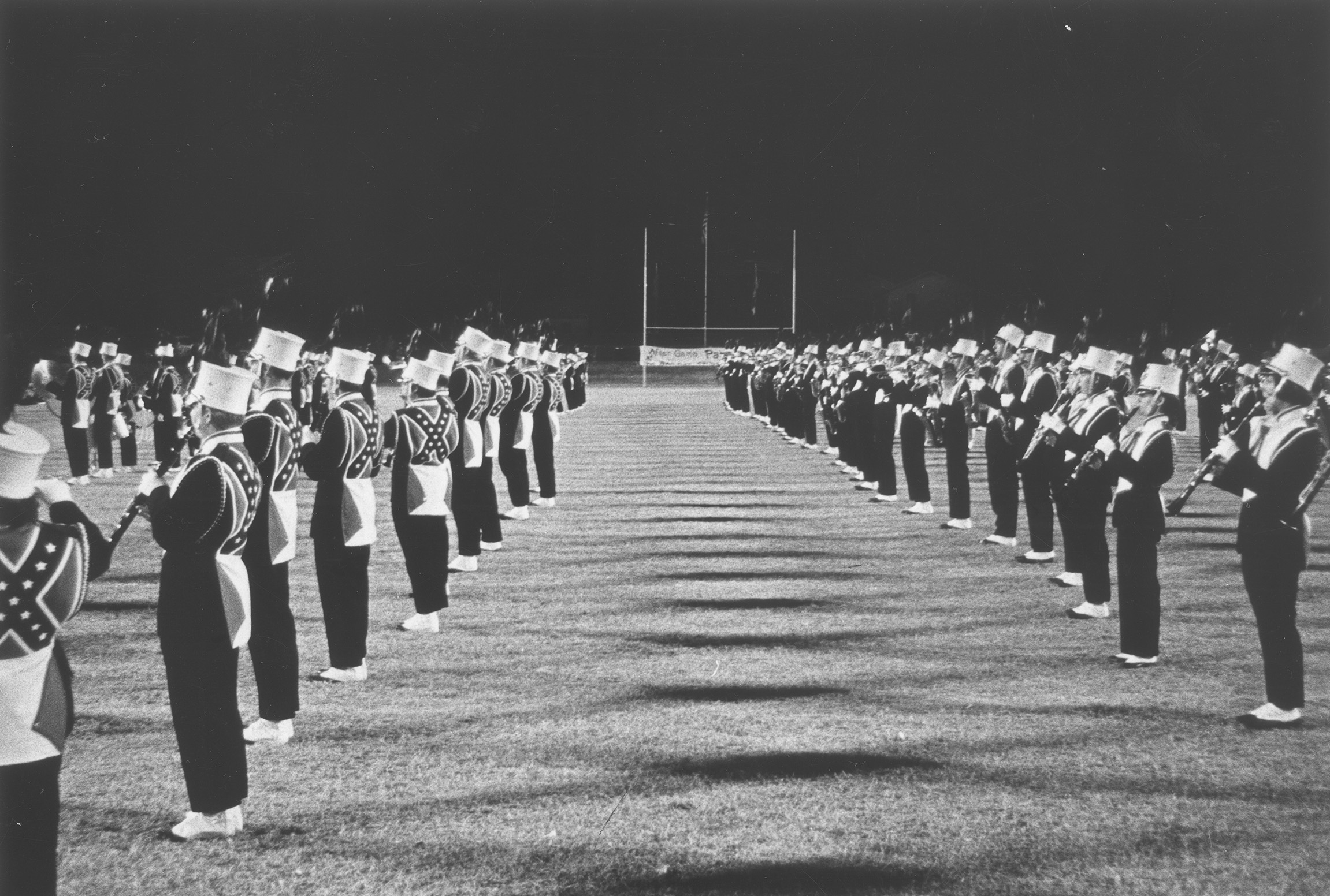 The Arlington State College marching band performs, representing music and school spirit at campus events.