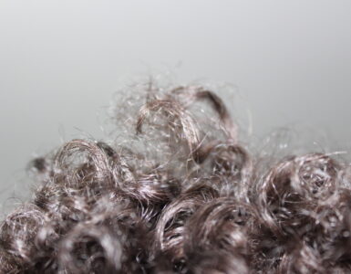 Curly hair with visible bends and strands, useful for explaining why humid air can increase frizz.