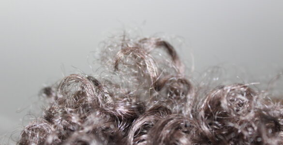 Curly hair with visible bends and strands, useful for explaining why humid air can increase frizz.