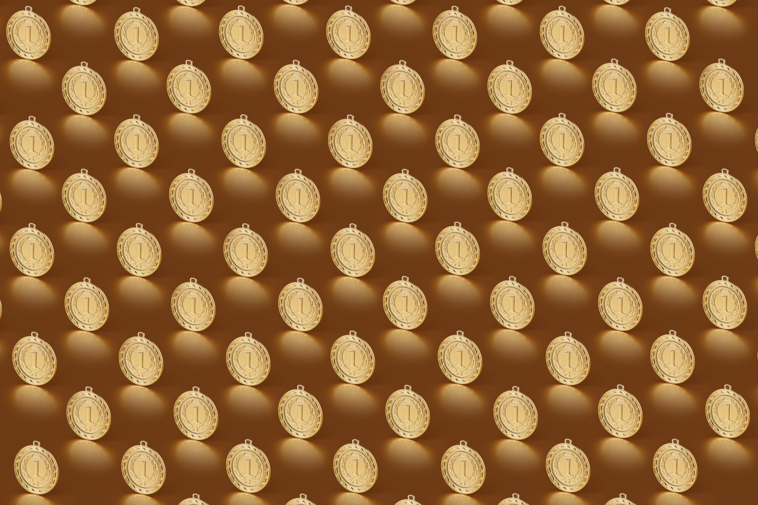 Several gold medals arranged in rows on a dark background.
