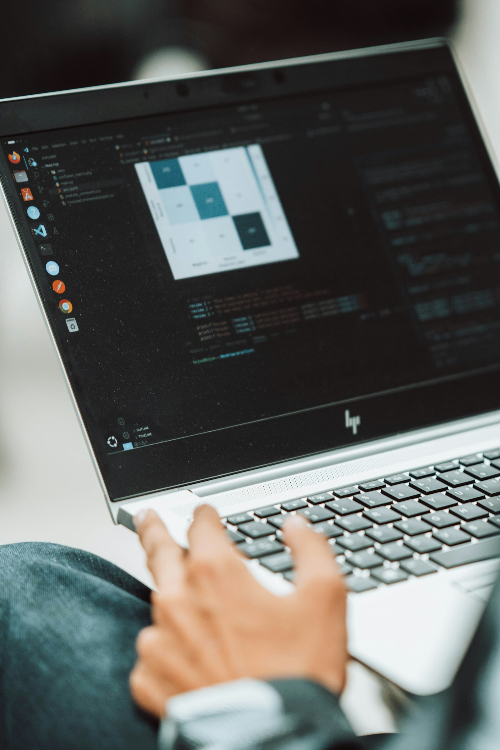 A student using a laptop, representing how matrix multiplication supports computer graphics transformations.