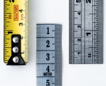 Rulers and measuring tapes marked in centimeters, millimeters, and inches