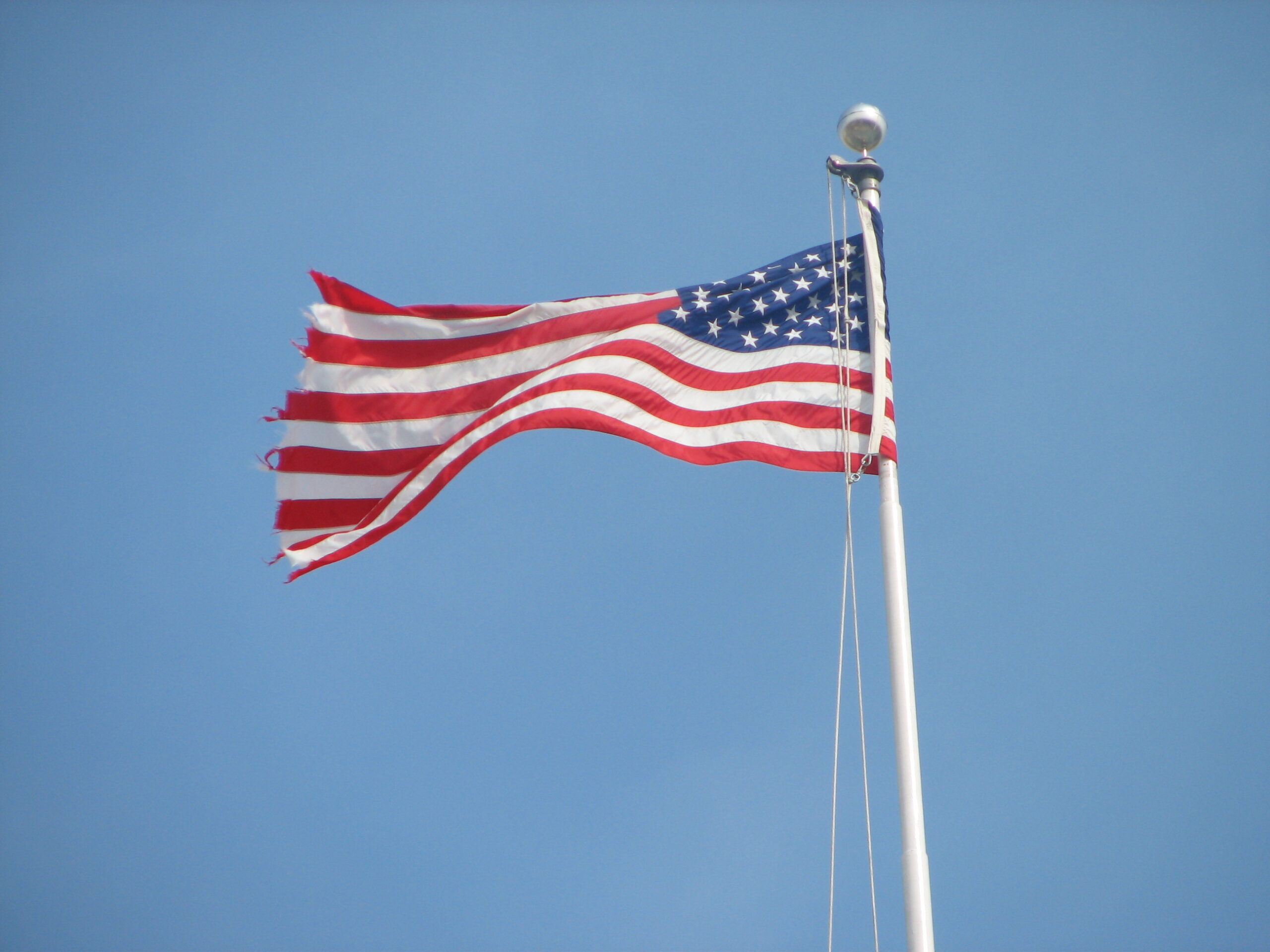 An American flag above the U.S. Capitol, representing Congress's role in proposing constitutional amendments.