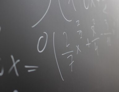 Mathematical equations written in chalk across a classroom blackboard.