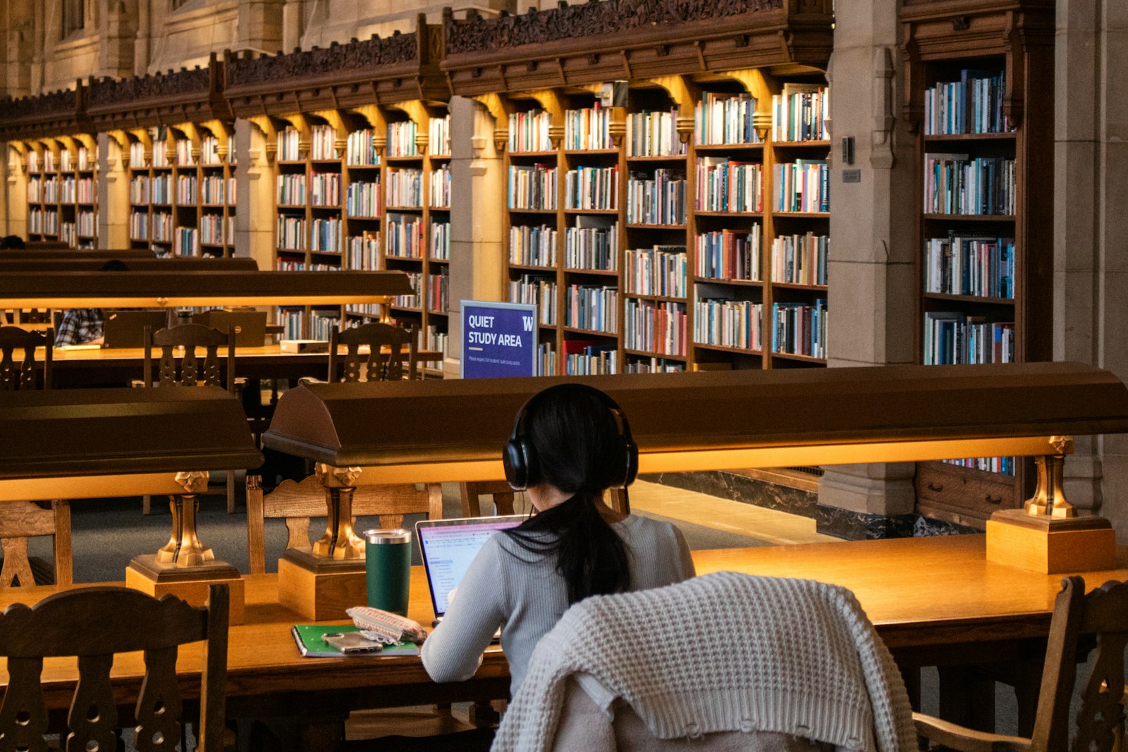 A student works with sources in a library, representing the careful review behind major award decisions.