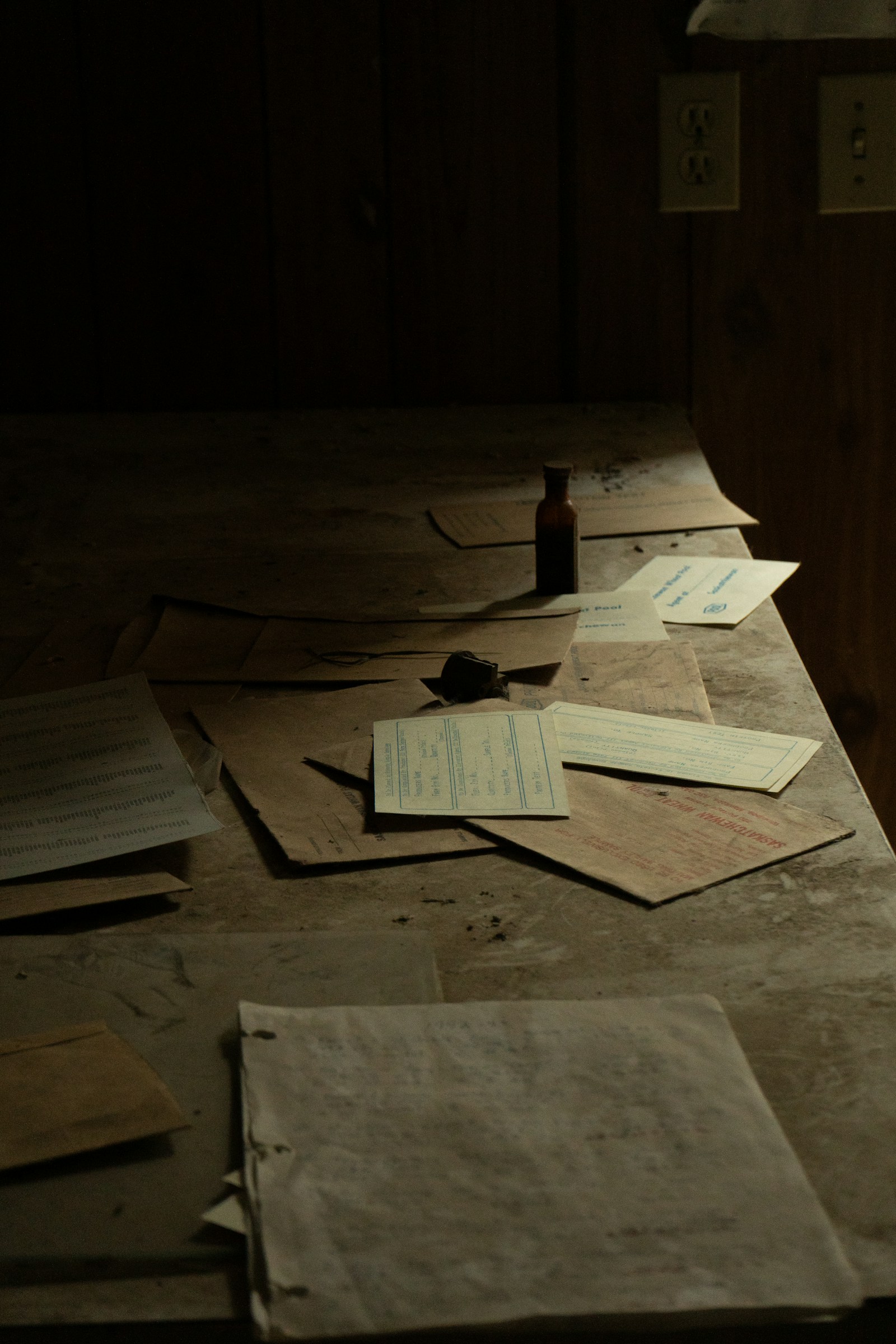 Old papers resting on a wooden desk in natural light