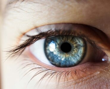 Close-up of a human eye, representing how vision depends on incoming light and the brain's interpretation.