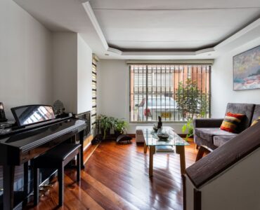 Grand piano in a bright living room, where seasonal indoor humidity can affect tuning.