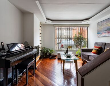 Grand piano in a bright living room, where seasonal indoor humidity can affect tuning.