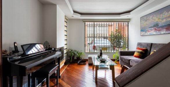 Grand piano in a bright living room, where seasonal indoor humidity can affect tuning.