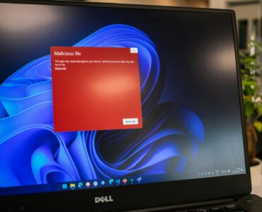 Laptop displaying a red security warning screen