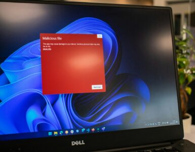 Laptop displaying a red security warning screen