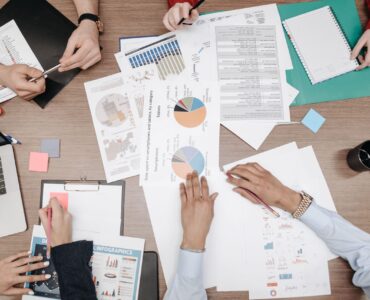 People review printed charts while checking which cases may be missing from a dataset.