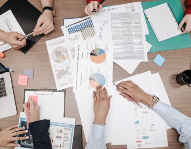 People review printed charts while checking which cases may be missing from a dataset.