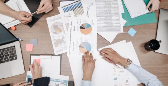 People review printed charts while checking which cases may be missing from a dataset.