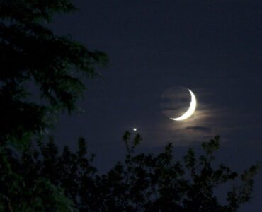 Bright Venus shining beside a thin crescent Moon in the evening sky.